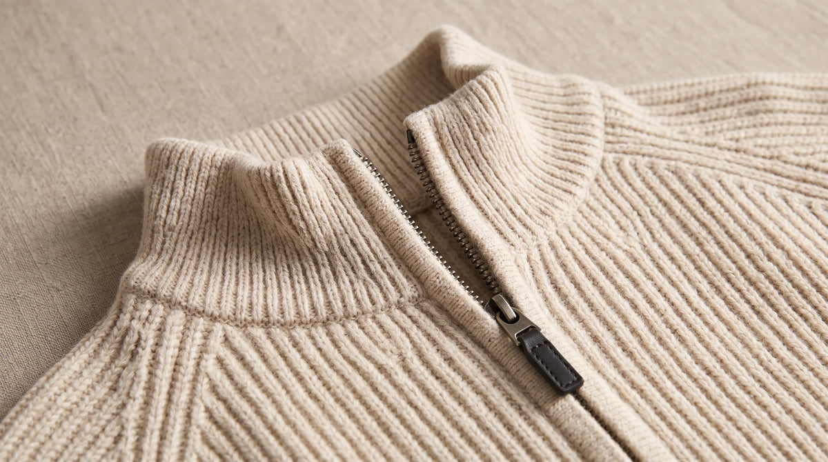 Close-up of the Como Beige Half-Zip Knit's ribbed collar and half zip
