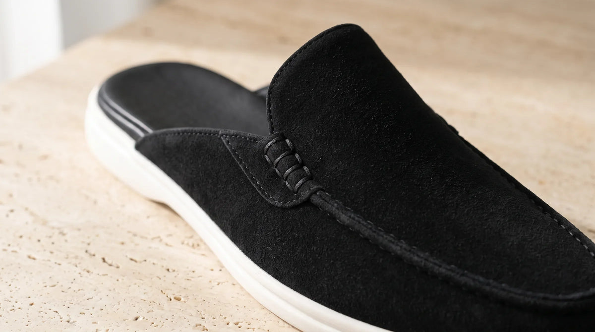 Close-up of the Cove Black Mule's stitched apron toe