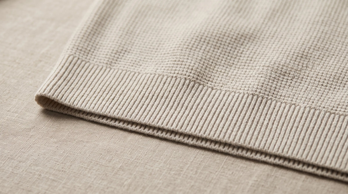 Close-up of the Lerici Apricot Knitted Sweater's hem and waffle knit