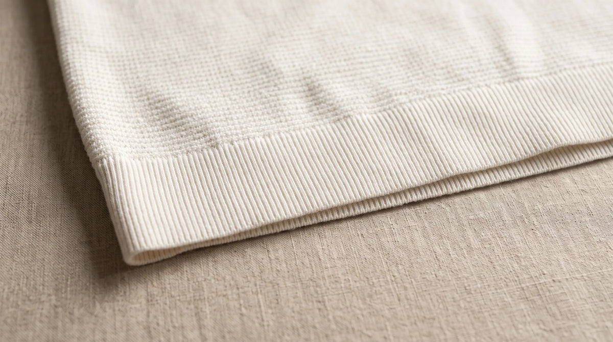 Close-up of the Lerici White Knitted Sweater's hem and waffle knit