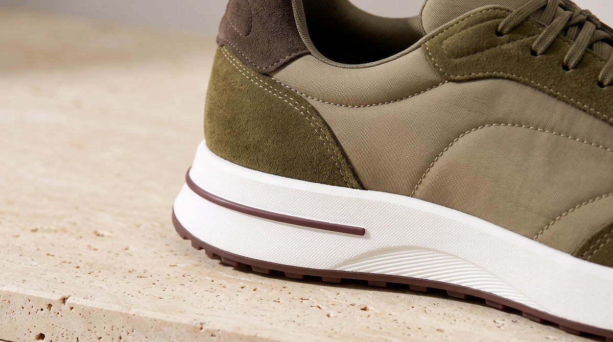 Close-up of the Olive Cove Trainer's striped sole and heel