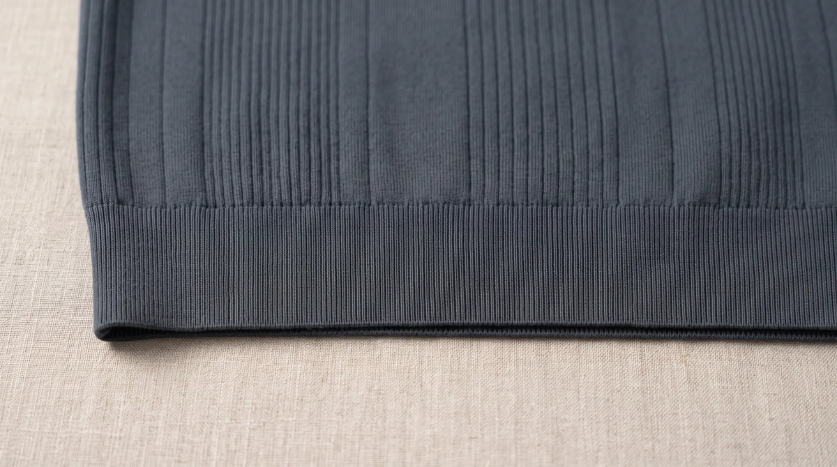 Close-up of the Pieve Knitted Sweater's ribbed hem and fine rib knit