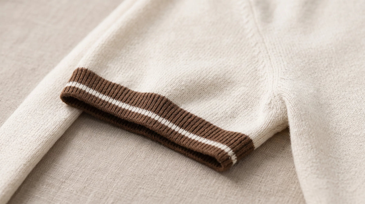 Close-up of the Recco Knit Polo's tipped cuff and fine textured knit