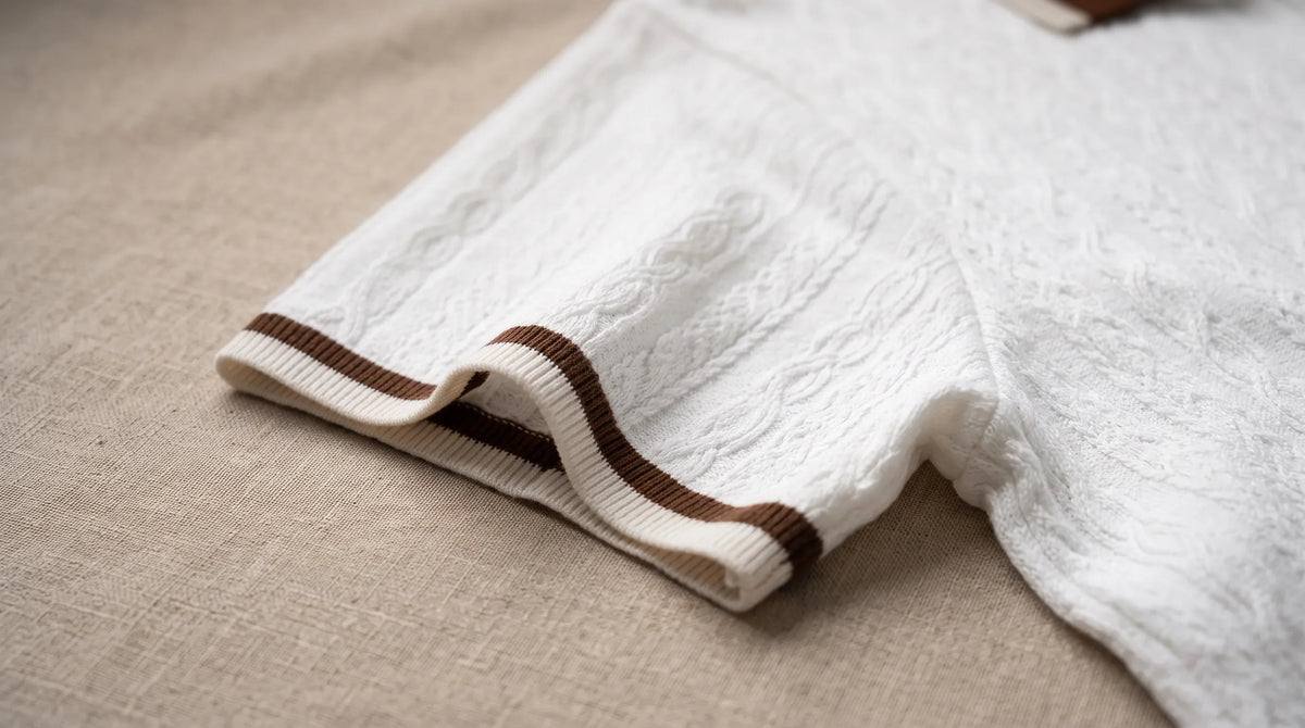 Close-up of the Sestri Knit Polo's tipped cuff and fine cable texture