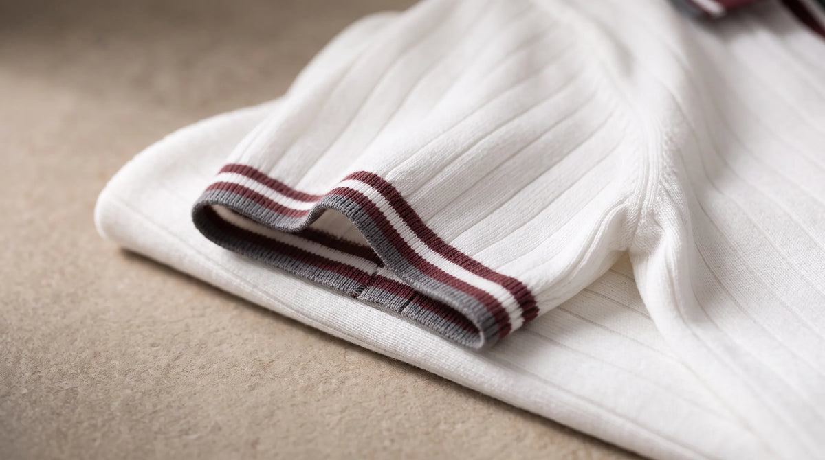 Close-up of the Tellaro Knit Polo's striped cuff tipping and fine rib knit