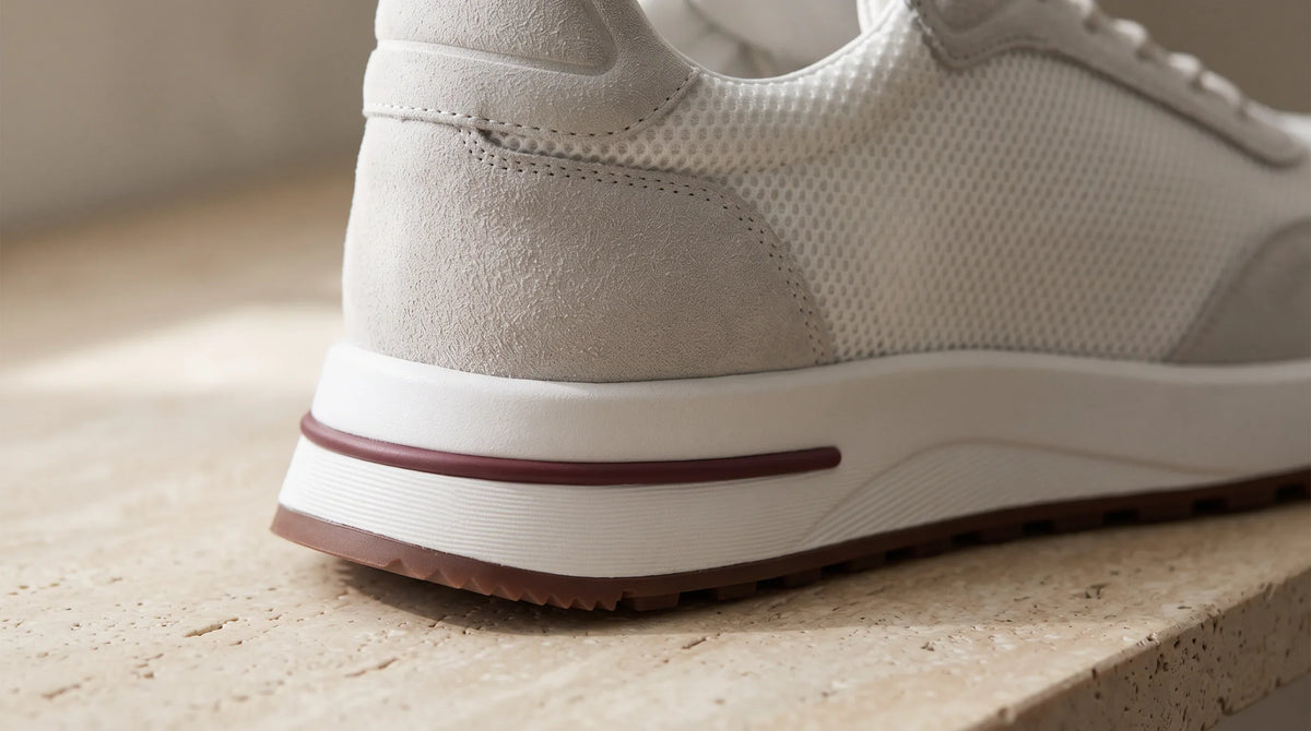 Close-up of the White Cove Trainer's striped sole and heel