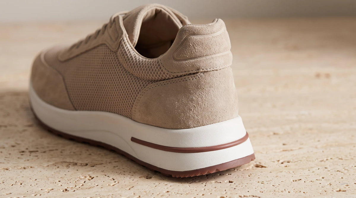 Close-up of the Beige Cove Trainer's striped sole and heel