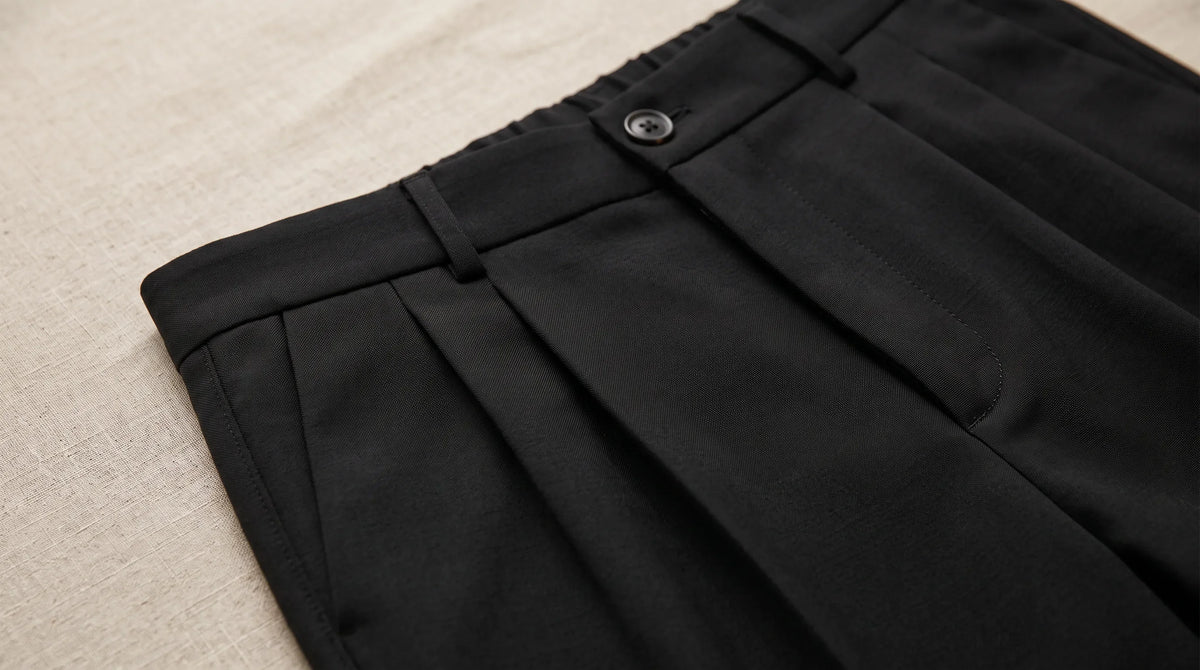 Close-up of the Cinque Terre Pleated Trouser's waistband and double pleats