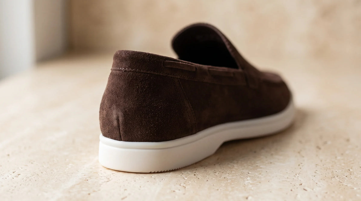 Close-up of the Coffee Yacht Loafers' white sole and napped upper