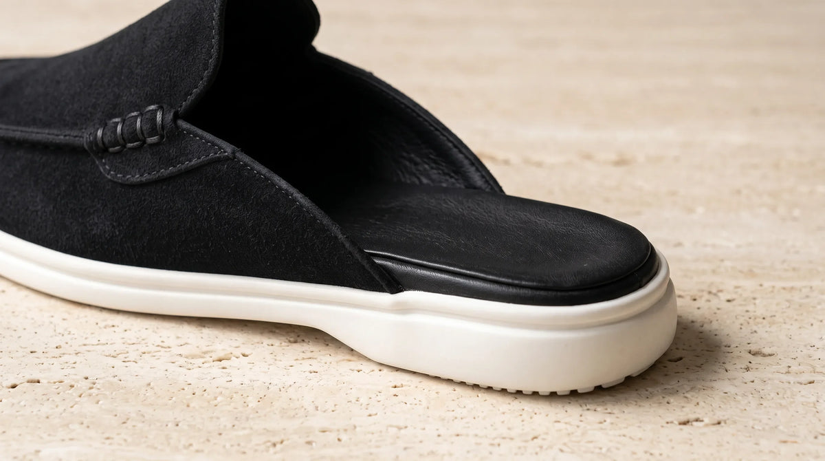 Close-up of the Cove Black Mule's open back and white sole