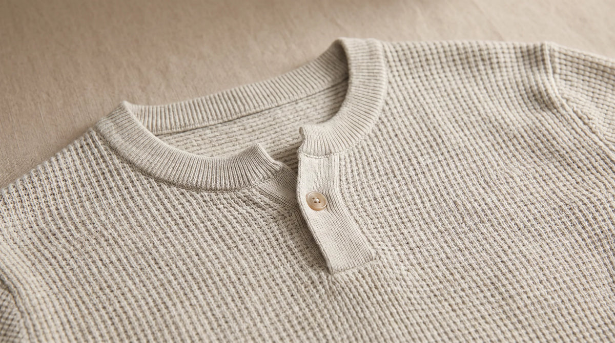 Close-up of the Lerici Apricot Knitted Sweater's henley button placket
