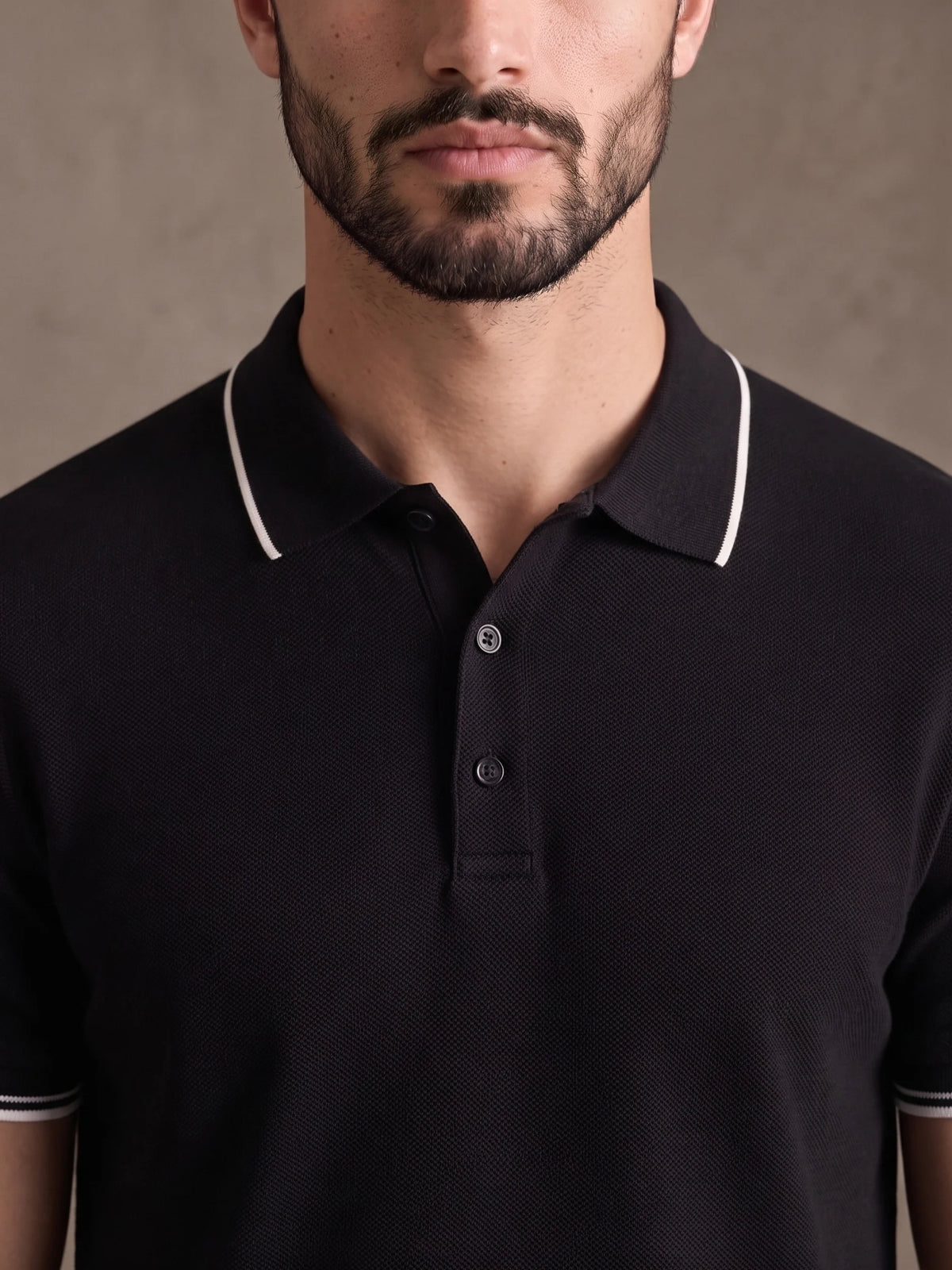 Close-up of the white-tipped collar and three-button placket