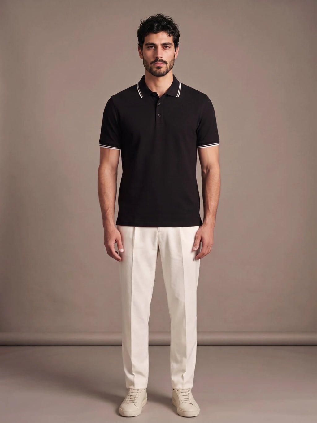 Model wearing the Morino Black Polo with ivory trousers