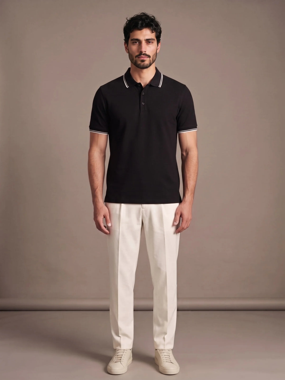 Model wearing the Morino Black Polo with ivory trousers