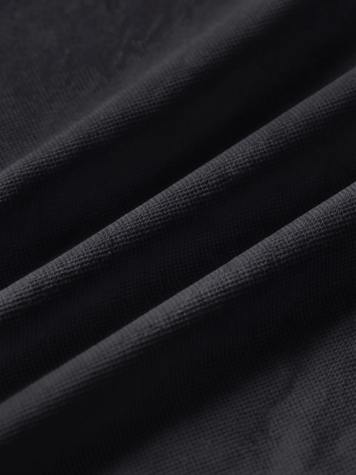Close detail of the black bamboo-fibre piqué