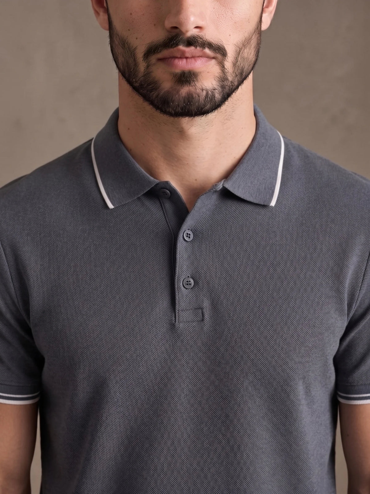 Close-up of the white-tipped collar and three-button placket