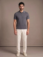 Model wearing the Morino Charcoal Polo with ivory trousers