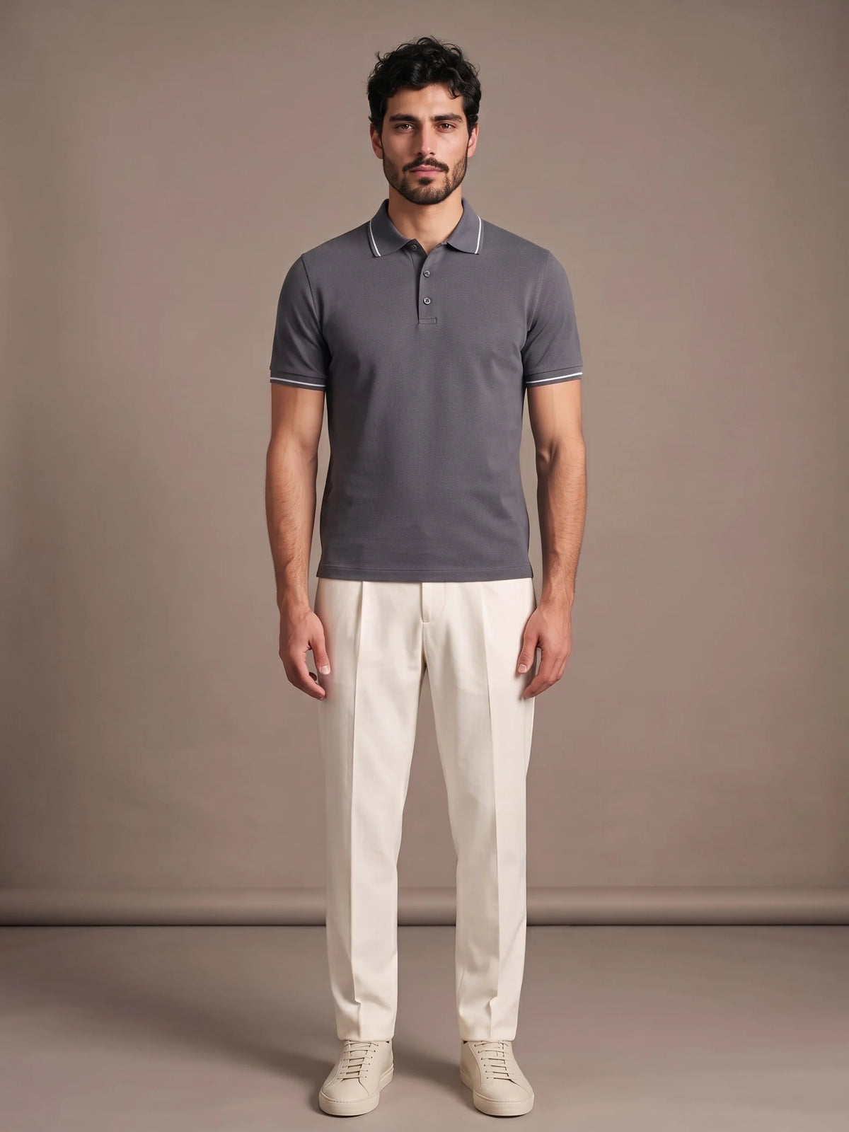 Model wearing the Morino Charcoal Polo with ivory trousers