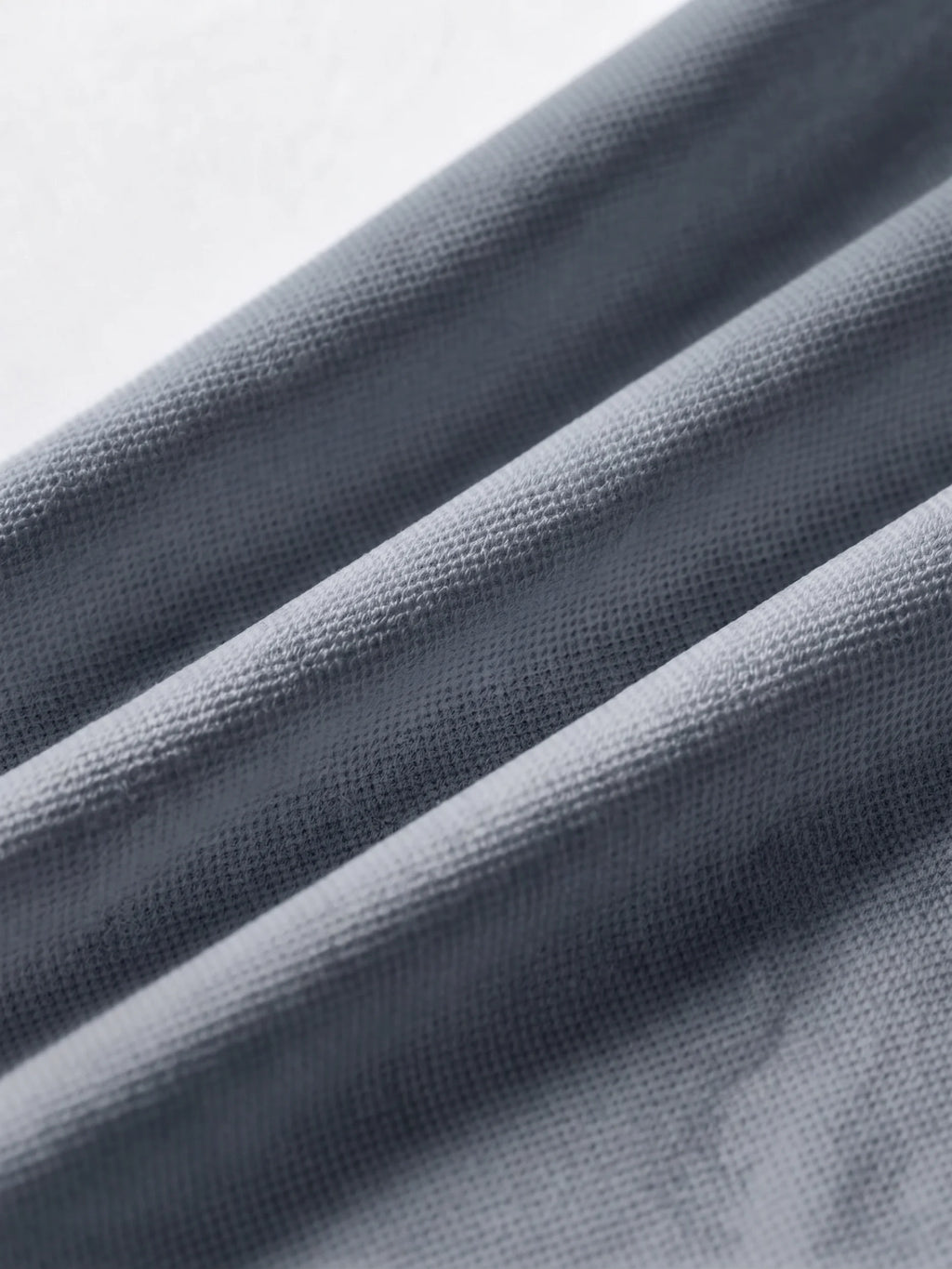 Close detail of the charcoal grey bamboo-fibre piqué