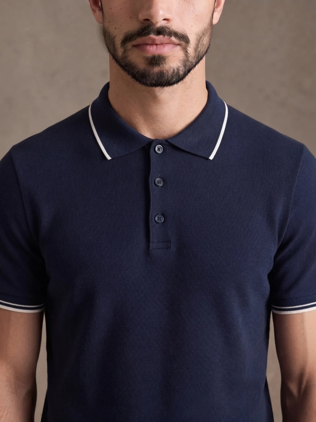 Close-up of the white-tipped collar and three-button placket