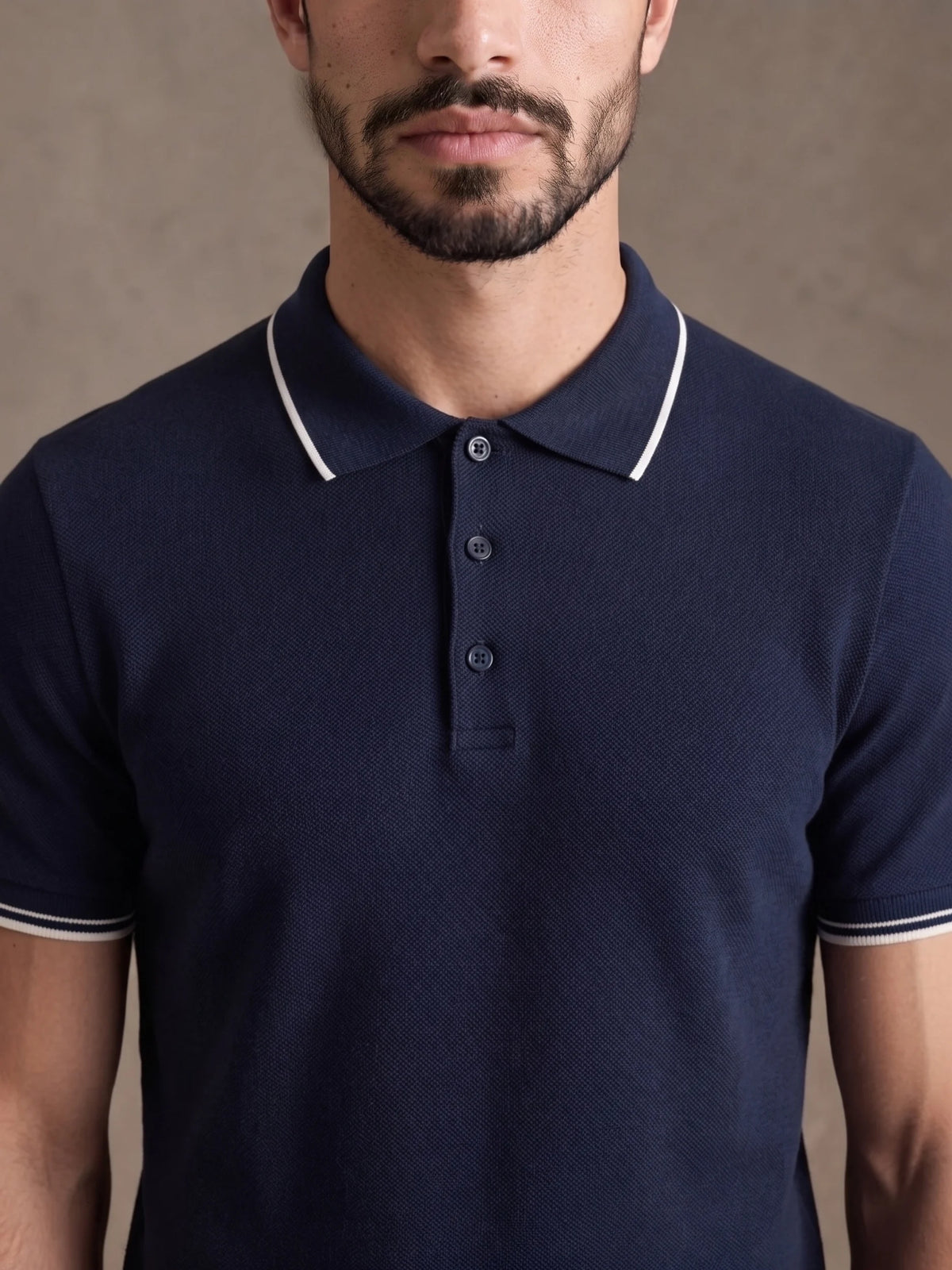 Close-up of the white-tipped collar and three-button placket