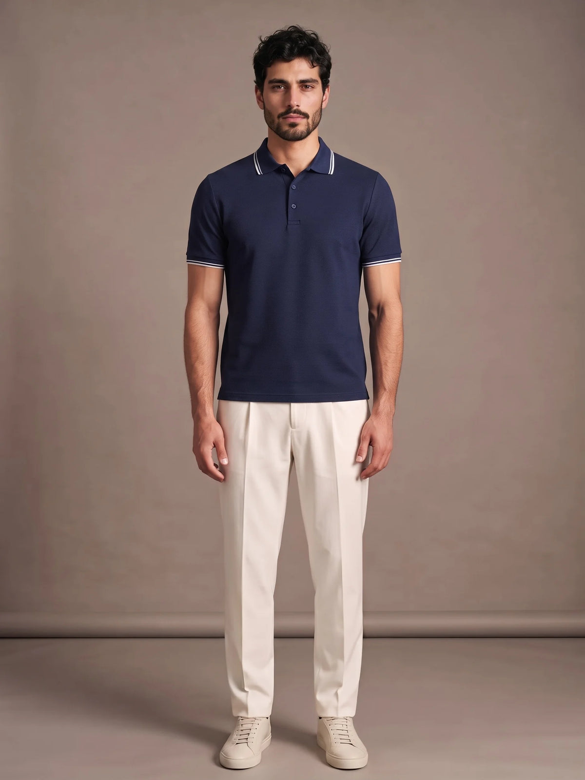 Model wearing the Morino Navy Polo with ivory trousers