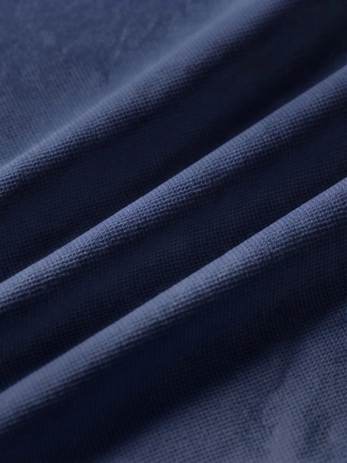 Close detail of the navy bamboo-fibre piqué
