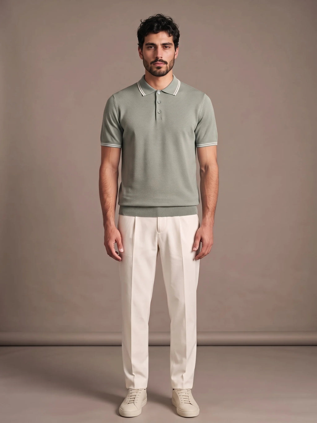 Model wearing the Morino Sage Polo with ivory trousers