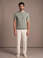 Model wearing the Morino Sage Polo with ivory trousers