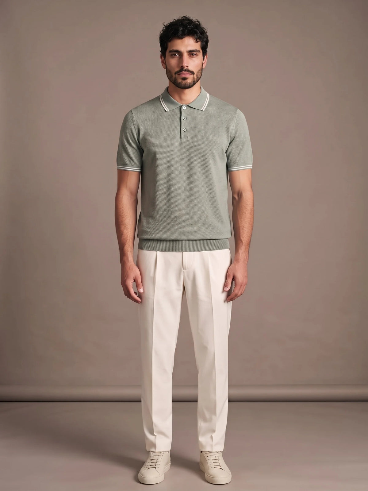 Model wearing the Morino Sage Polo with ivory trousers