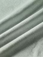 Close detail of the sage green bamboo-fibre piqué