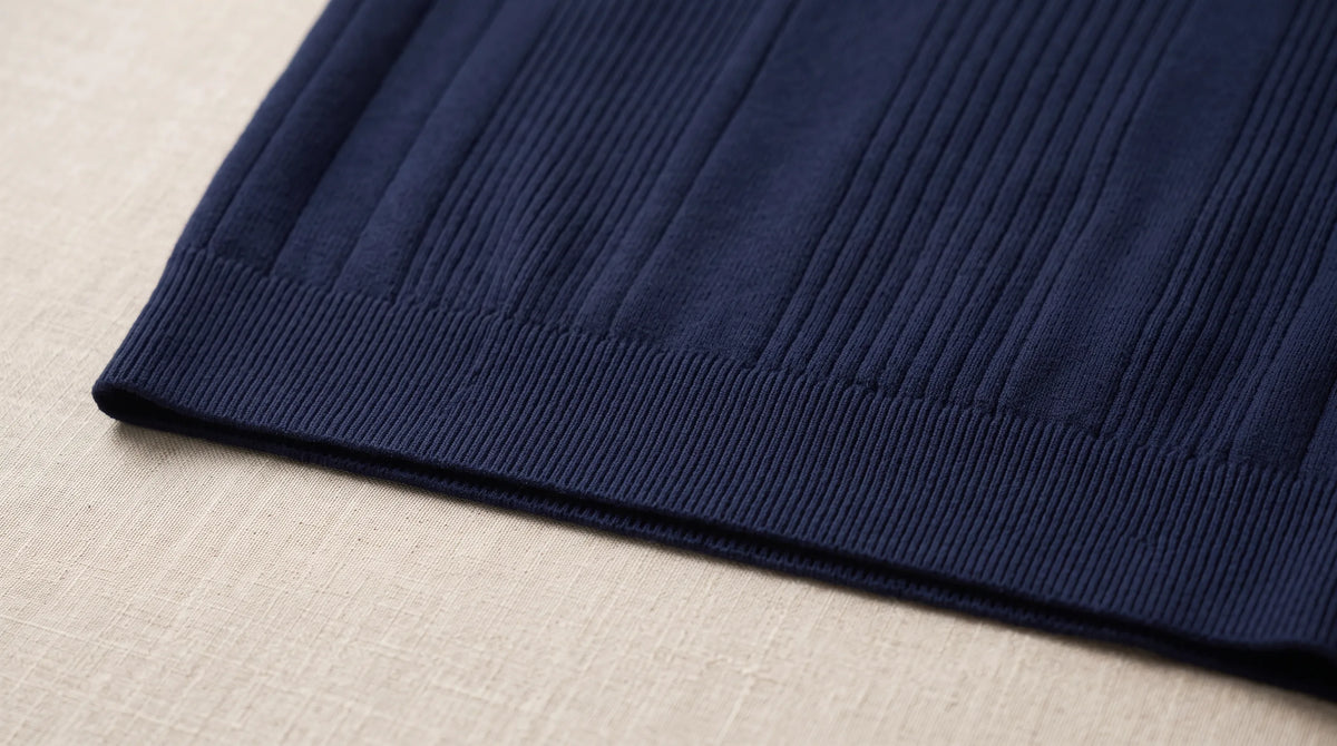 Close-up of the Portovenere Knitted Sweater's ribbed hem and fine rib knit