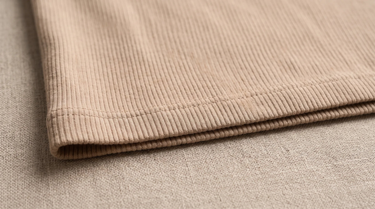 Close-up of the Ravello Beige Henley's hem and fine rib knit