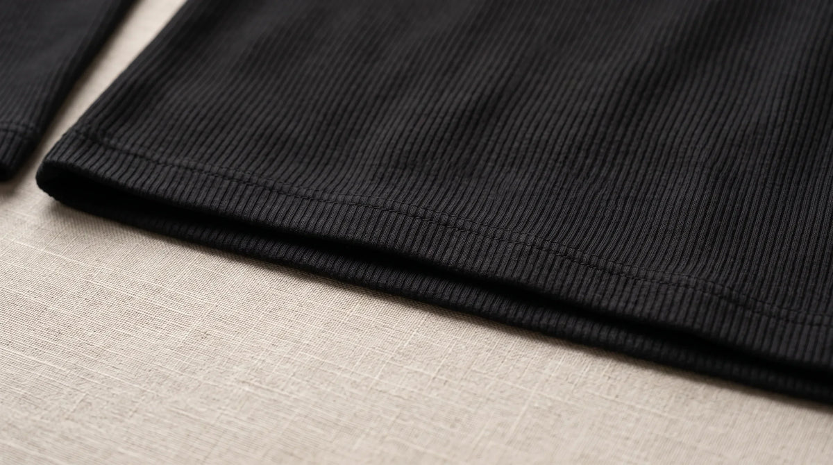 Close-up of the Ravello Black Henley's hem and fine rib knit