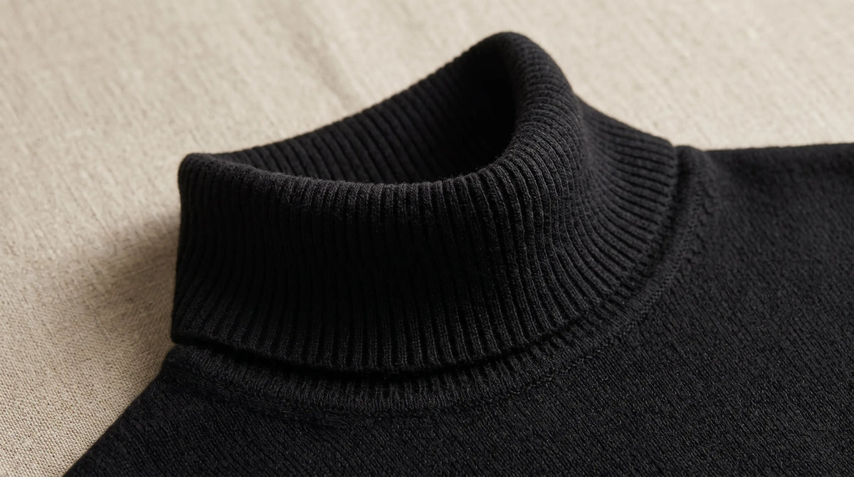 Close-up of the Riva Black Roll-Neck's folded roll neck