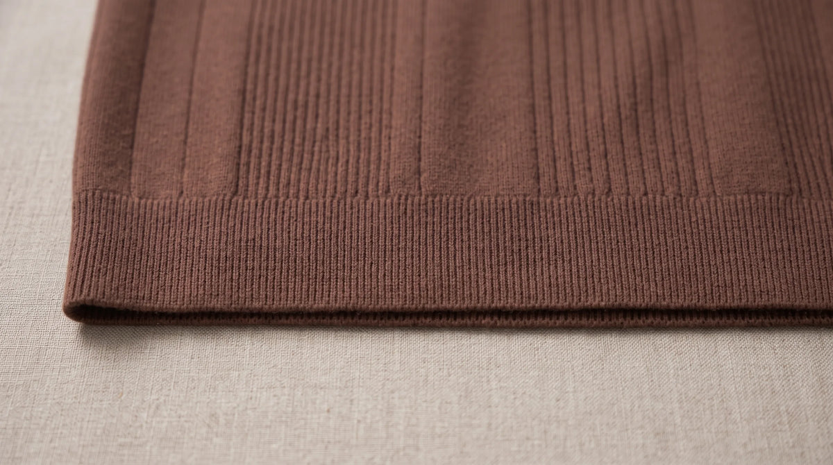 Close-up of the Sarzana Knitted Sweater's ribbed hem and fine rib knit