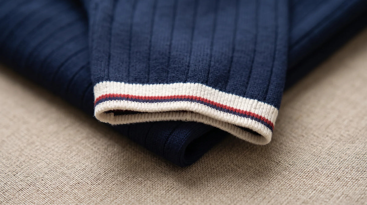 Close-up of the Vernazza Knit Polo's striped cuff tipping